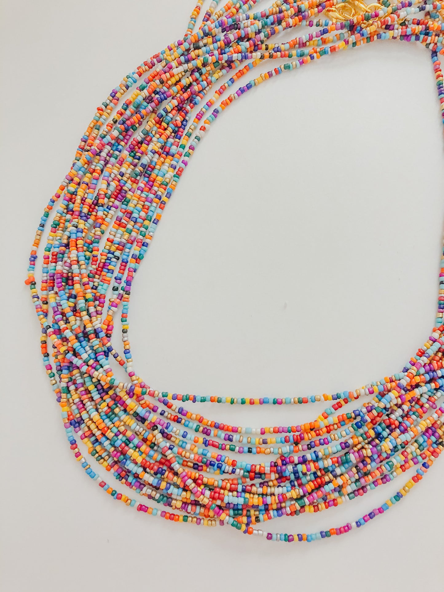 This sunglass chain is made of very small beads and is a very thin chain. It is many different colors in no pattern or order.