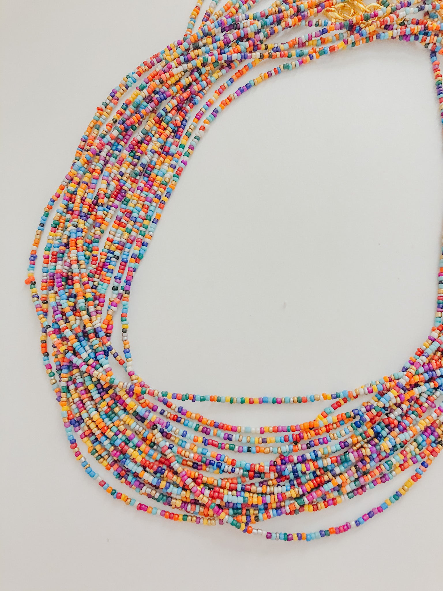 This sunglass chain is made of very small beads and is a very thin chain. It is many different colors in no pattern or order.