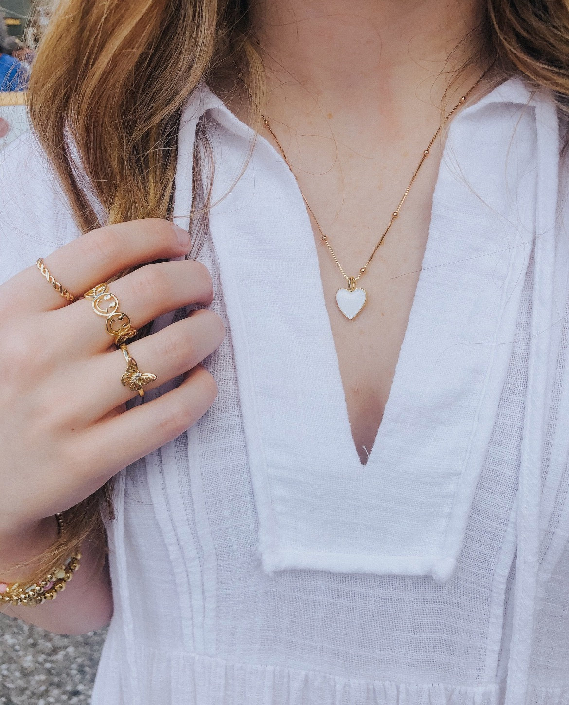 This ring is multiple smiley faces together in a line. The smiley faces gold outlined, but hollow in the middle. It is open in the back and adjustable.