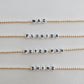 these bracelets are small gold beads with white and black letter beads that are able to spell out whatever you decide. 