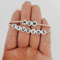 these bracelets are small gold beads with white and black letter beads that are able to spell out whatever you decide. 